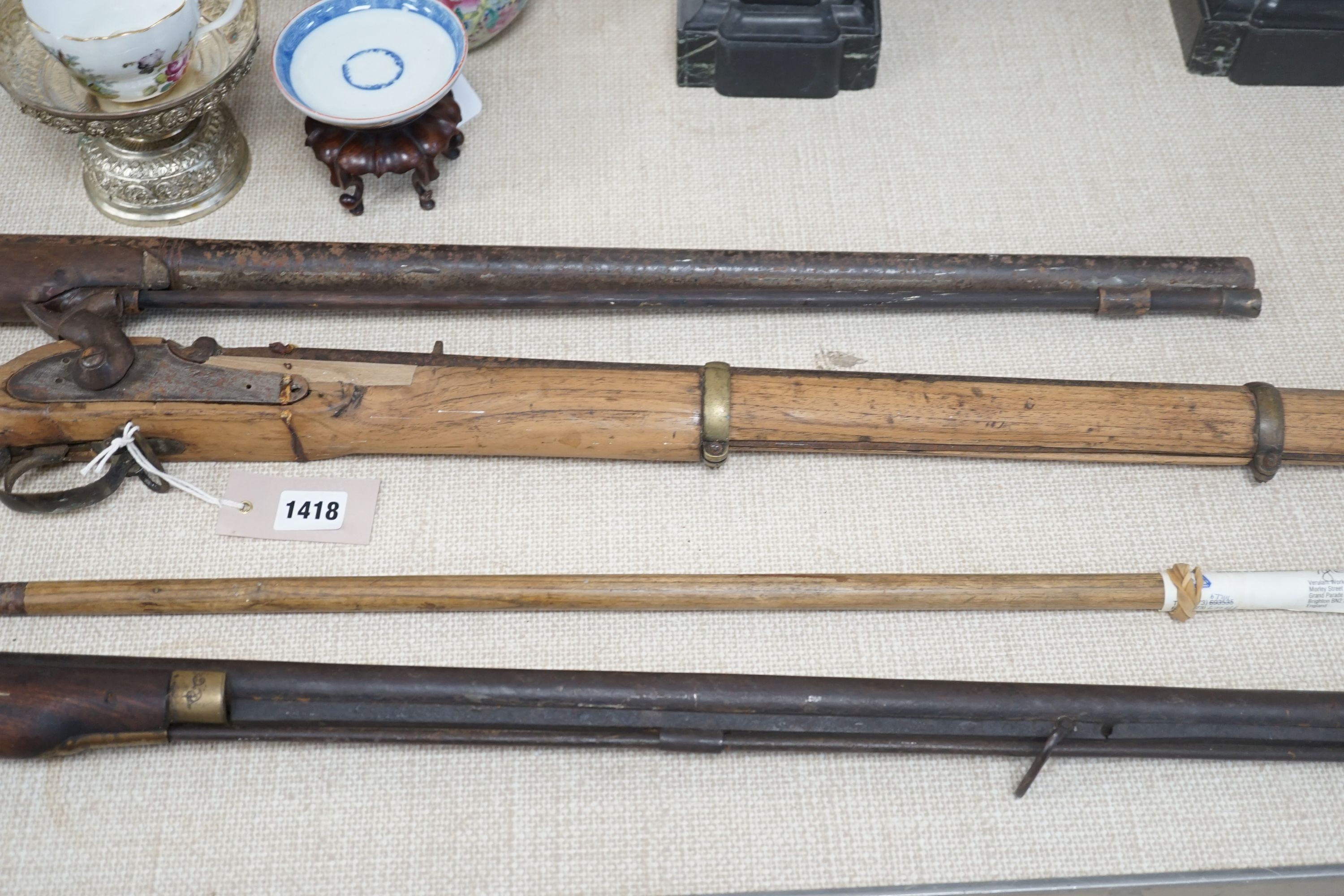 Three 19th century percussion rifles, (each in need of restoration), and a Belgian ramrod, longest 134 cms.